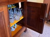 a cabinet that has a lot of glasses on it