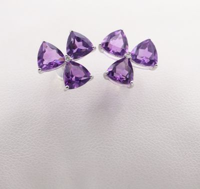 a pair of purple amethorate earrings on a white background