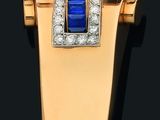 une broche en or jaune 18 carats, sertie de saphirs et de diamants