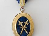 a close up of a medal with a blue ribbon around it