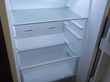 an empty refrigerator with the door open and no food inside