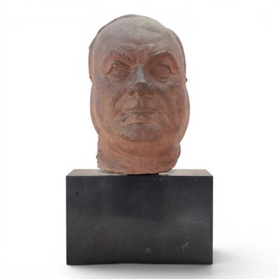 sculpture of a man ' s head on a black stand