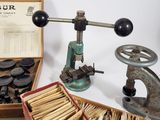 a box of old tools sitting on a table next to a box of old books