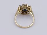 a close up of a gold ring with a black and white diamond