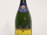 a close up of a bottle of champagne on a white surface