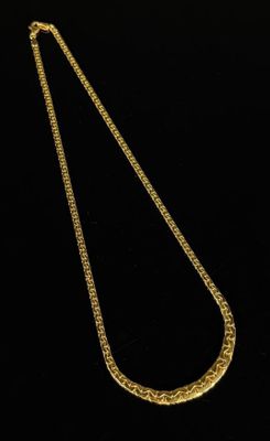 a gold necklace on a black background
