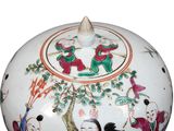 a white bowl with a painting on the lid