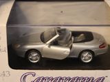 a silver toy car in a box on a table