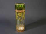 a green glass vase with a gold decoration on it