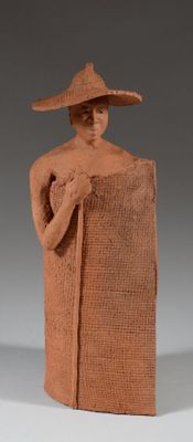 statue of a woman with a hat and a cane in a sack