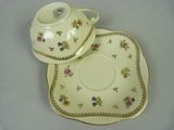 a cup and saucer on a plate on a table
