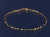 un bracelet en chaîne dorée sur un fond noir
