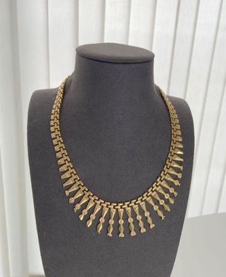 a close up of a mannequin with a necklace on it