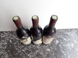 three bottles of wine that are sitting on a table