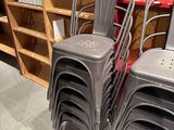 many chairs that are stacked on top of each other