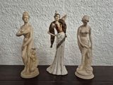 three statues that are sitting on a table