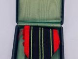 a medal in a case with a cross on it