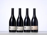 three bottles of wine are lined up on a table