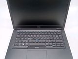 the dell laptop is open and ready to use on the desk