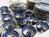 a lot of blue and white dishes and cups
