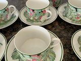 several cups and saucers are sitting on a counter top