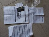 two pieces of paper on the floor next to a plastic bag