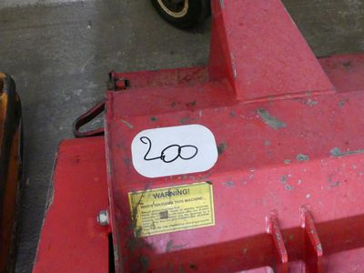 a red tractor with a sticker on the front