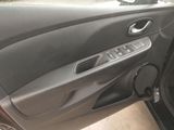 the interior of a car with the door open and a speaker in the passenger seat