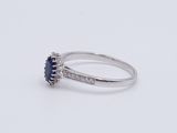an oval sapphire and diamond ring on a white background
