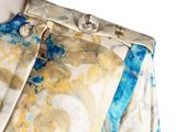 the back view of a woman ' s dress with a blue, yellow and white design