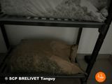 a bed with a pillow on top of it in a room