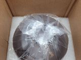 a chocolate donut in a box wrapped in plastic wrap