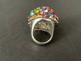 a close up of a silver ring with multi colored stones on it