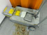 a small metal box with a yellow label on it