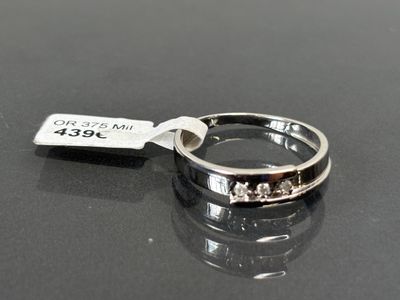 a silver ring with a tag on it on a table