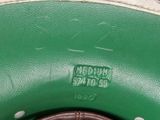 a close up of a green purse with a brown handle
