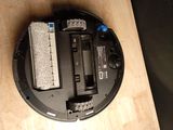 a black robot that is sitting on a wooden table