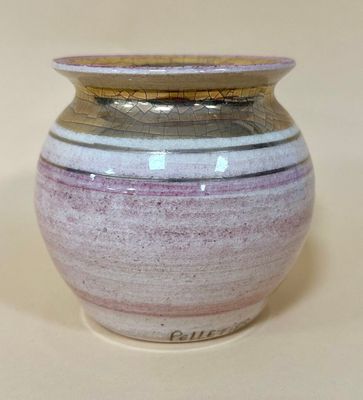 a purple and white vase sitting on a white surface