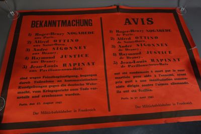 un panneau orange avec une inscription noire, posé sur une table