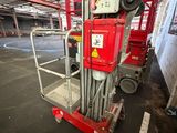 an image of a red scissor in a warehouse
