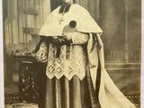 an old black and white photo of a man in a priest ' s robes