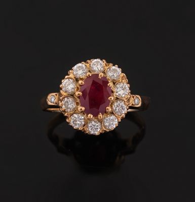 an oval ruby and diamond cluster ring