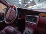 a car dashboard with a steering wheel and a clock on it