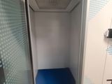 a small elevator with a blue mat in the middle of it