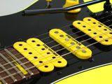 a yellow electric guitar that is sitting on a table