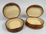 two small wooden boxes are sitting on a white surface