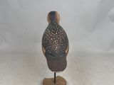 a small bird that is standing on a wooden stand