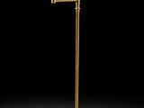 a brass plated floor lamp with a glass shade and a ball on the base