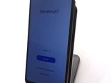 the back of a phone with a blue screen on a stand