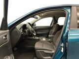 the interior of a blue car with the driver ' s door open
